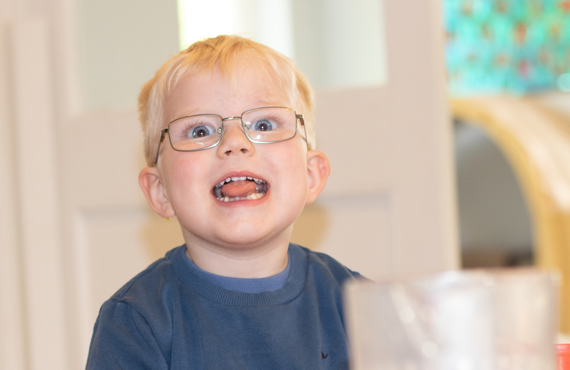 Blonde child playfully pulling a funny face