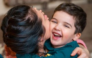 Son Hugging Mother And Smiling