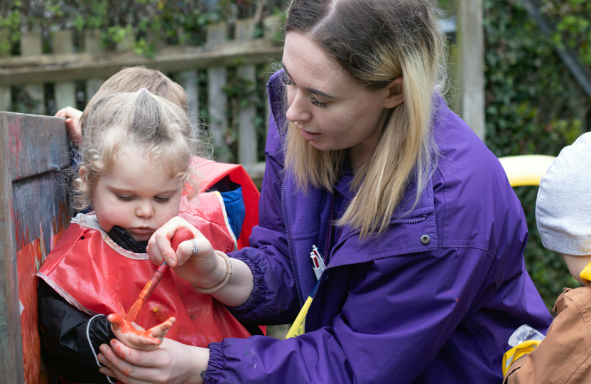 Our Apprenticeship Program – The Mulberry Bush Children painting in the outdoor garden at The Mulberry Bush, Waterlooville
